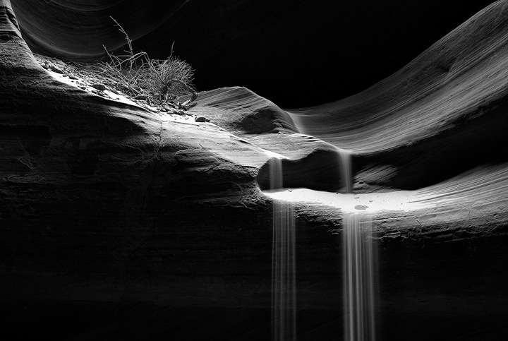 Spot-lit sand falls